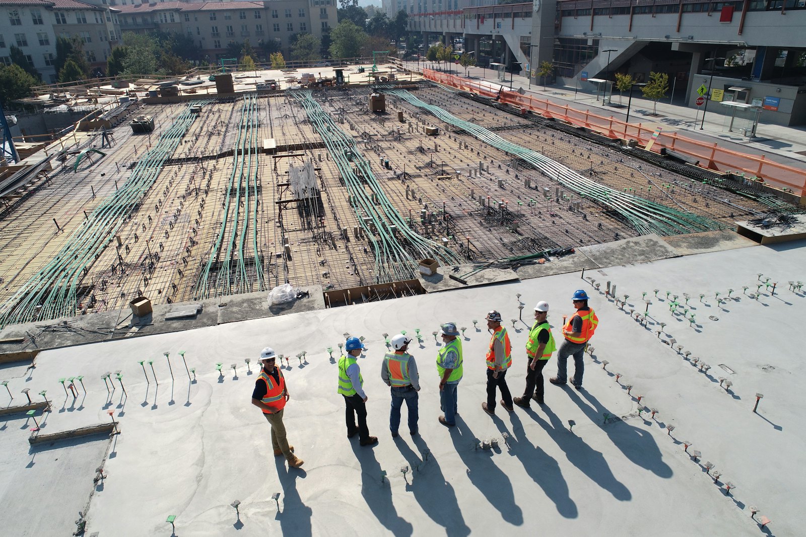 A site team walking a freshly poured slab
