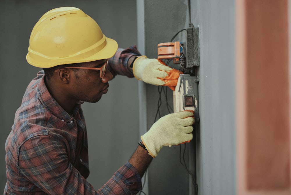A site worker fitting an electrical box
